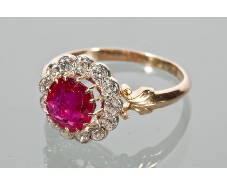 RUBY AND DIAMOND CLUSTER RING
the central round ruby surrounded by diamonds totalling approximately 0.80 carats, unmarked, te