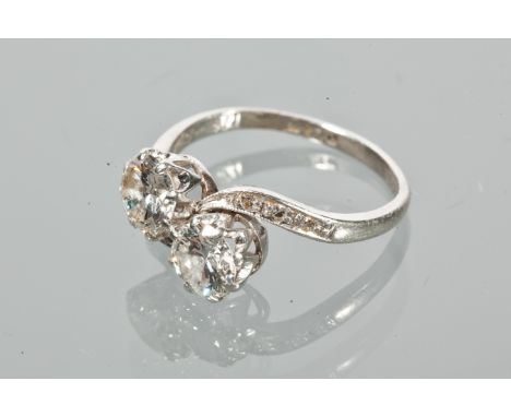 EDWARDIAN DIAMOND TWO STONE RING
with two brilliant cut diamonds totalling approximately 1.24 carats, in a twist setting, on 