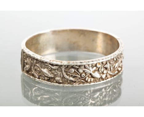 NINETEENTH CENTURY CHINESE SILVER BANGLE
with fish motifs and moulded border, with Chinese mark