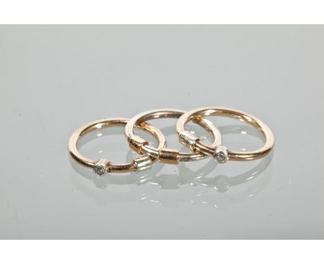 THREE GOLD STACKING RINGS
two set with a single round diamond, each marked 375 for nine carat gold, size K