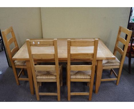 A pine dining table and chairs for four, 75cm high x 152cm wide x 91cm deep