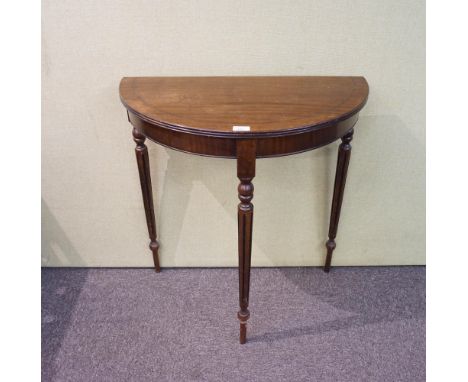 A demi lune side table, in mahogany, 74cm high