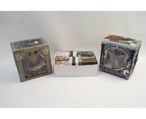 Two Lord of the Rings figures, boxed, together with a box of various playing cards etc