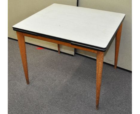 A draw leaf table, finished in formica