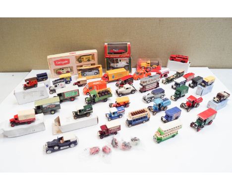 A group of boxed model cars and others