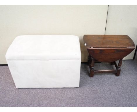 An oak drop leaf table and an ottoman