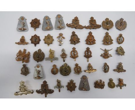 Selection of Corps Cap Badgesincluding QC bi-metal WRAC ... KC brass RA ... KC brass RE ... KC brass RAMC ... KC bi-metal RAP
