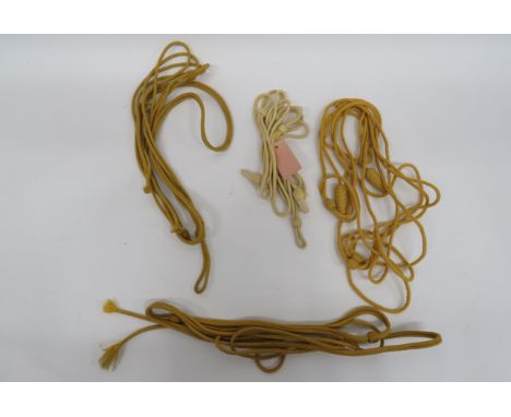 Four Various Busby Cordsconsisting light yellow/cream example ... Yellow cord example with lower knots ... 2 x yellow cord ex