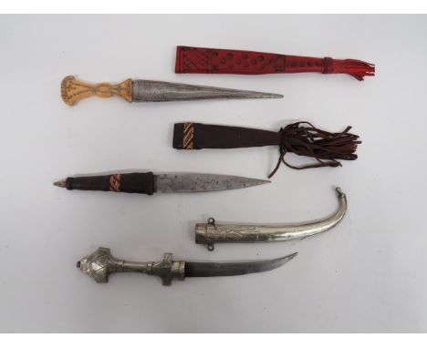 Three Various African Knivesconsisting white metal jambiya. Double edged, curved blade. Floral decorated, white metal grip an