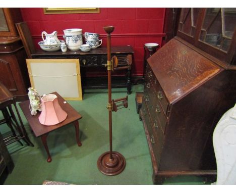 A late Victorian mahogany floor-standing height-adjustable double-arn wool holder with cupped finial, brass mounts and turned