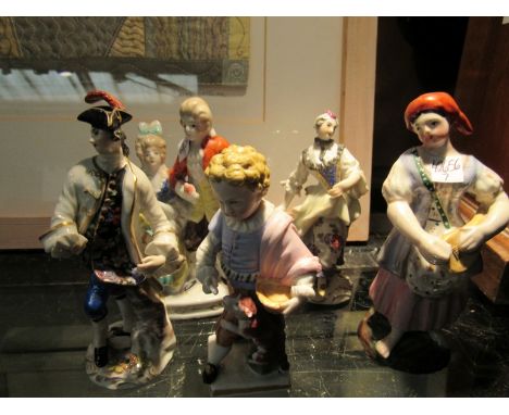 Five figures and figural groups including Staffordshire examples, courting couple, boy with dog and lady holding lute, some a