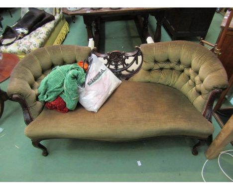 A Victorian mahogany show frame sofa the carved and deep button back rest over cabriole legs