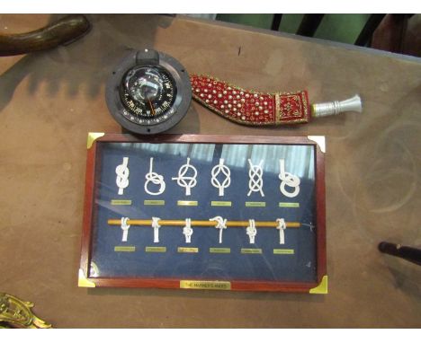 A knot board display case, ship's compass and two British flags 