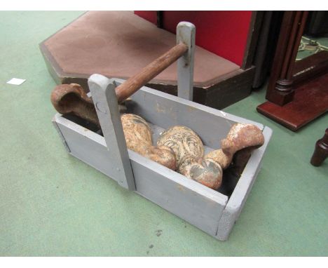 Four Victorian cast iron ball and claw bath feet in a blue painted tool trug 
