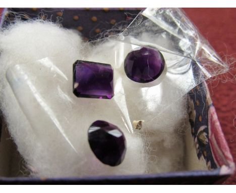 Three amethyst coloured stones