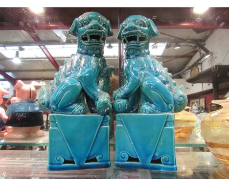 A pair of Oriental Dog of Fo ceramic ornaments in turquoise 