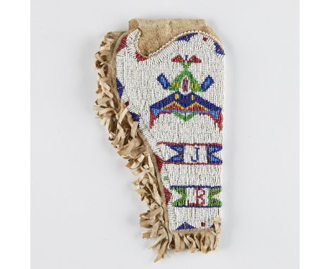 Native American holster for a gun. Fringed hide with beadwork along one side in white, blue, red, and green, depicting a geom