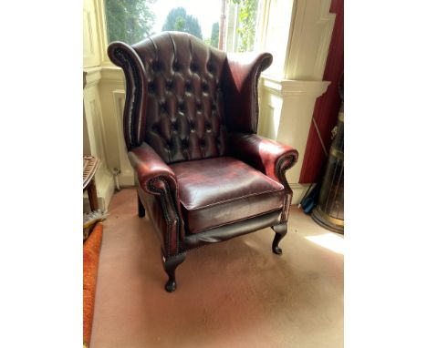 A button back leather Wing Armchair, with loose cushion seat on front cabriole legs. (1) 