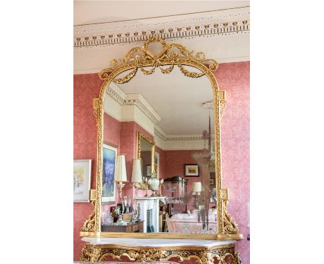 An extremely attractive 19th Century gilt Console or Overmantel Mirror, crested with a circular leaf swag and two crossed qui