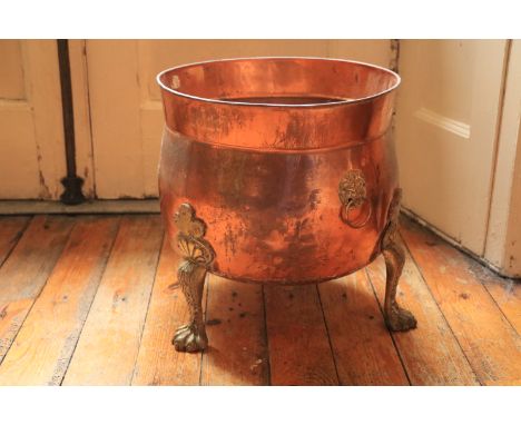 A brass mounted copper Planter or Fuel Bin, with lion paw feet, 14 1/2'' x 15'' (37cms x 38cms). (1) 