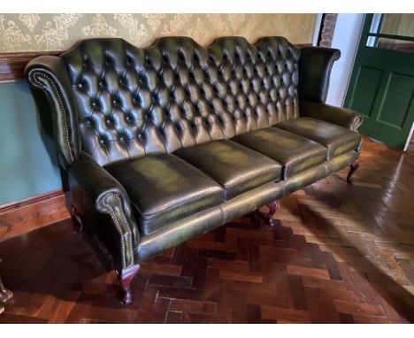 A button back four seater Wing Back Settee, covered in dark hide with four cushion seat on cabriole legs, 95'' (241cms). (1) 