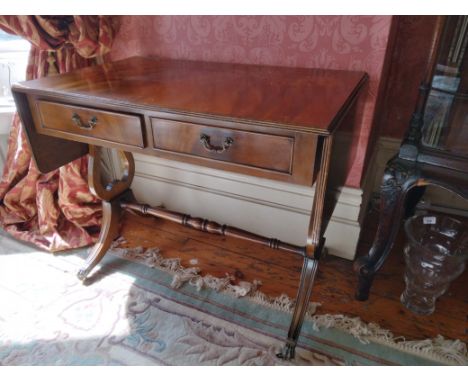 A Georgian style mahogany Sofa Table, the plain top with d-end flaps and reeded edges, over two frieze drawers with brass han