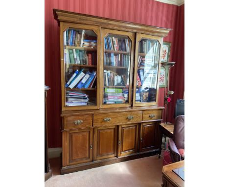 An inlaid mahogany three door Library Bookcase, with moulded cornice above three glazed doors, three frieze drawers and three