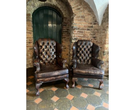 A pair of Chippendale style button back Wing Library Armchairs, each with loose cushion on front leaf carved cabriole legs wi