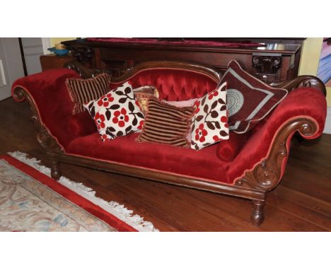 A Victorian mahogany Settee, the arched and moulded back with a padded button panel and two scroll ends with bolster cushion 