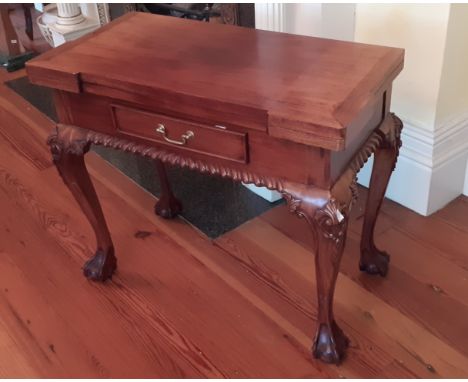 A Chippendale style fold-over mahogany Games Table, for backgammon, chess and draughts, with inlaid boards and frieze drawer,