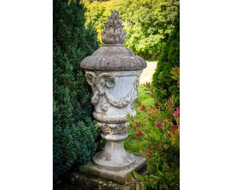 A massive pair of 19th Century composition stone Garden Urns and Covers, each cover with a flame finial, egg and dart moulded
