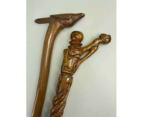 TWO FOLK ART WALKING STICKS, comprising one with twisted snake, heart, anvil, etc carved stem (snakes with glass bead eyes), 