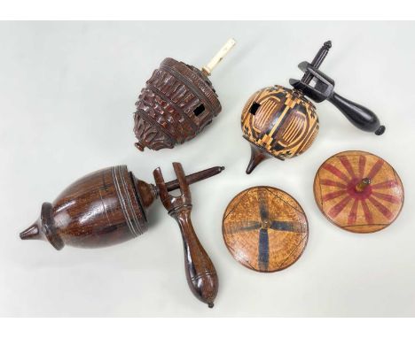 FIVE VARIOUS TREEN SPINNING TOPS, including one parquetry humming top with handle, rosewood humming top with handle, engine t