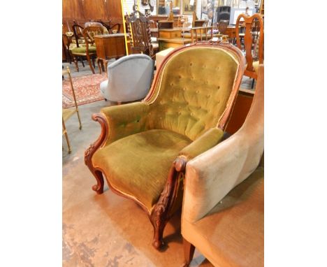 A Victorian button back armchair, with carved walnut frame, floral carved arms, with short cabriole legs