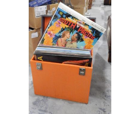 A brown canvas and wood school trunk, two vintage leather suitcases, another suitcase and a quantity of long playing records 