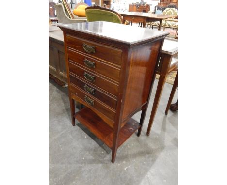 An Edwardian mahogany chest of five drawers, four with sheet music, hinged drawer fronts and open shelf below on square taper