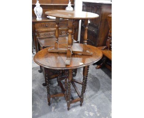 An oval oak drop-leaf gateleg table with spiral turned supports, an oak tea trolley and another item (3) 