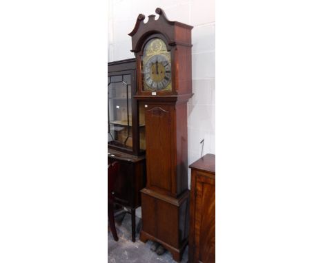 A Georgian style oak longcase clock with brass broken arch dial and eight-day striking movement, the silvered chapter ring in