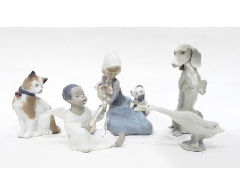 A Lladro group of a young girl seated with a puppy and kitten, a Lladro model of a seated angel musician, a Lladro goose, a N