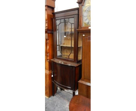 A mahogany glazed display cupboard, the upper section with astragal glazed panel enclosing two shelves, with an open cupboard