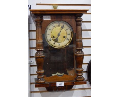 A stained wood wall clock with turned fore-pilasters and a Victorian marble and black slate mantel clock in architectural sty