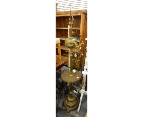 An early 20th century revived Grecian-style large brass standard lamp with waisted circular tray  