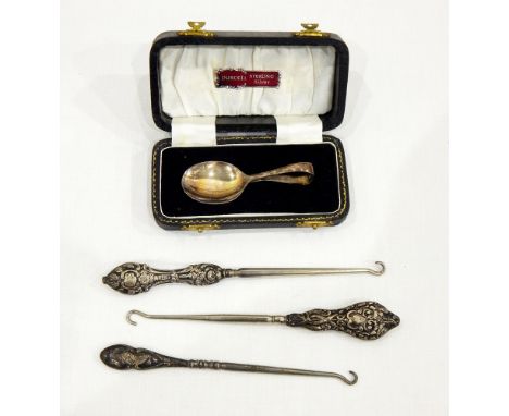 Three button hooks with silver handles, a pair of Victorian silver plated serving spoons, the gilt bowls with embossed floral