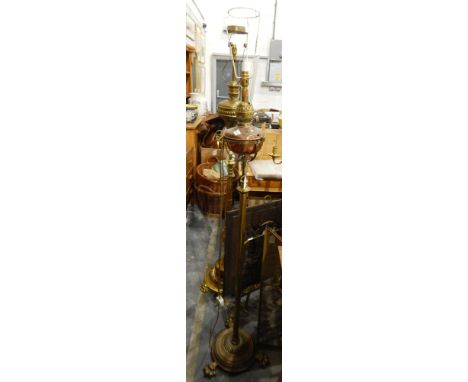 A copper and brass standard lamp, the top in the form of an oil lamp 