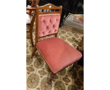 An Edwardian mahogany nursing chair, with button panelled back, upholstered seat, on ring turned legs with castors