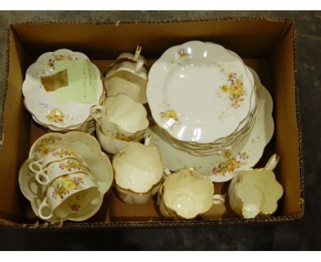 A part tea service by Chapman, white ground with orchid decorations and wavy and gilt edges to plates and mugs, with KPM Kirs