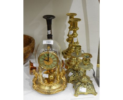 A pair of Victorian brass candlesticks, another pair of foliate form, an old telescopic candlestick, a brass cased mantel clo