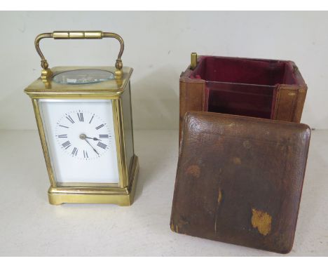 A late 19th century brass carriage clock striking on a gong with a travel case - Height with handle 18cm 
Condition report: I