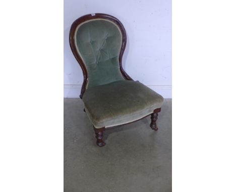 A Victorian walnut button back spoon shaped nursing chair 