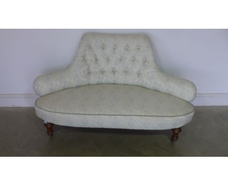 A 19th century mahogany framed smaller settee with button backed fabric upholstery, carved support with bowfronted on fluted 